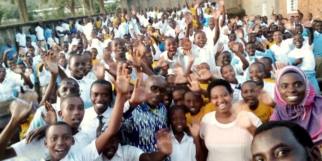 Students wave at the camera during a YIM school visit