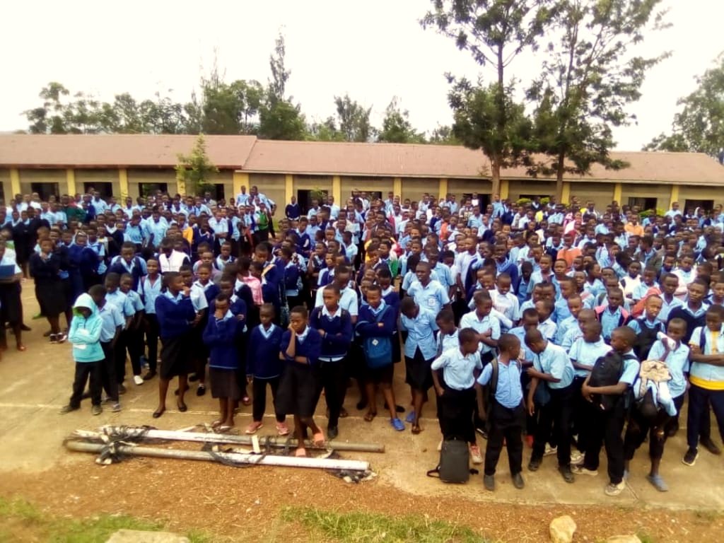 Students assembled in a school yard for a YIM visit